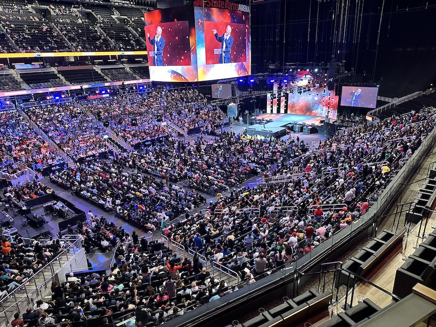 large-scale event in an arena. Multiple video displays and speakers make the event exciting for attendees.