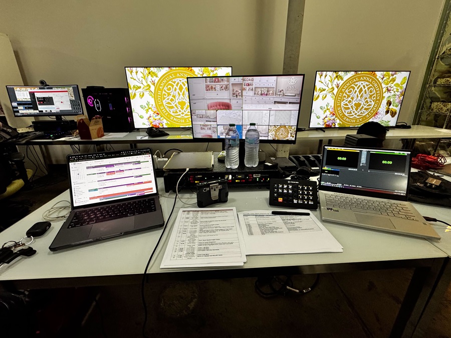 A production setup with laptops, monitors, and a detailed run sheet, showcasing event coordination tools